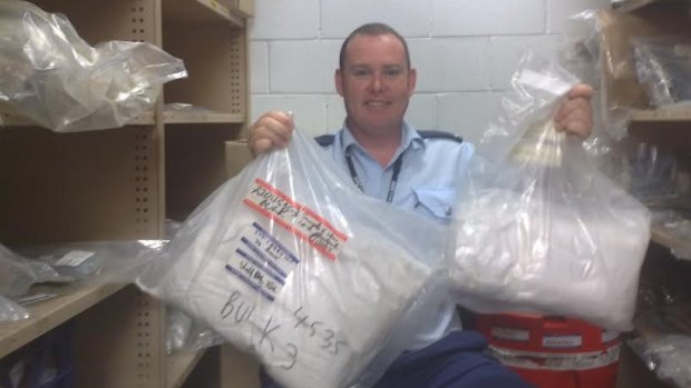 Former senior constable Andrew McGrath working in the drug exhibit vault of NSW Police in March 2009. He suffered serious respiratory and psychological injuries as a result of working there. 