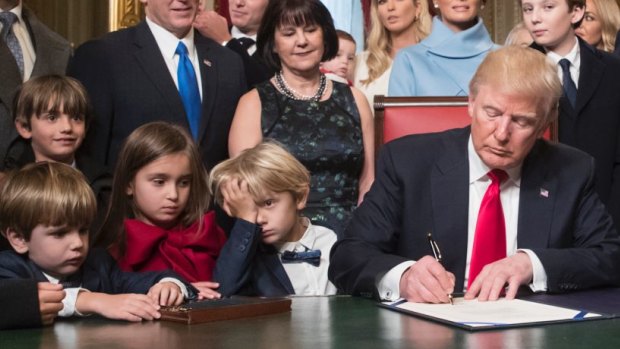 President Donald Trump is joined by the Congressional leadership and his family as he formally signs his cabinet nominations into law, Friday, Jan. 20, 2107, in the President's Room of the Senate on Capitol Hill in Washington From left are, Senate Majority Leader Mitch McConnell, R-Ky., Sen. Roy Blunt, R-Mo., Donald Trump Jr., Vice President Mike Pence, Jared Kushner, Karen Pence, Ivanka Trump, Melania Trump, Barron Trump, Speaker of the House Paul Ryan, R-Wis., Majority Leader Kevin McCarthy, D-Calif., House Minority Leader Nancy Pelosi, D-Calif. (AP Photo/J. Scott Applewhite, Pool)