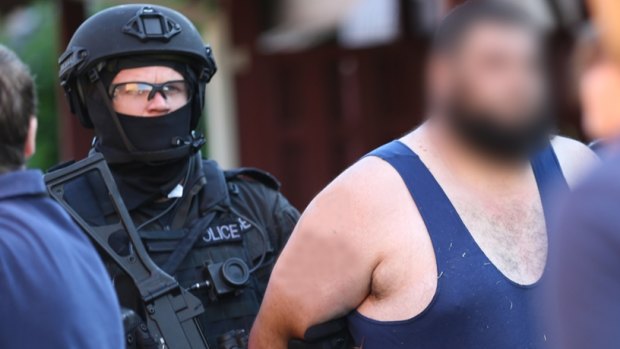 Police arrest a man during a counter-terrorism investigation.