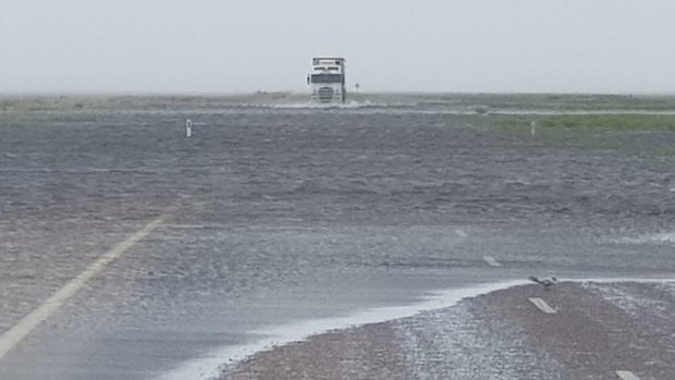 A road truck struggles through water, 30km out of Broome.