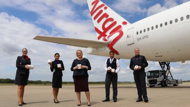 Virgin Australia staff clutch precious cargo, set to be donated to vulnerable people throughout Australia.