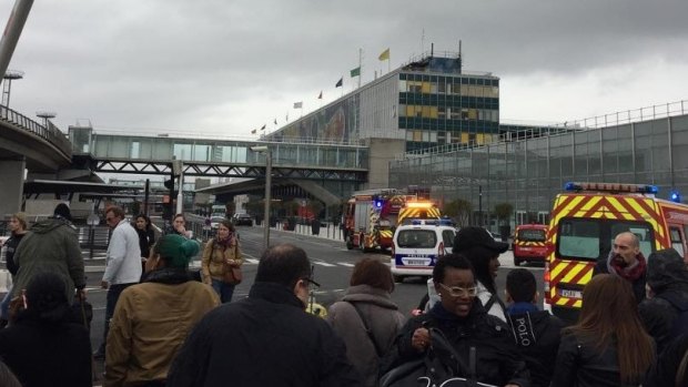 Passengers are evacuated from Orly airport in Paris after reports of shots fired.