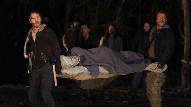 Rick (Andrew Lincoln) and Abraham (Michael Cudlitz) carry Maggie on a stretcher in The Walking Dead season six finale Last Day on Earth.