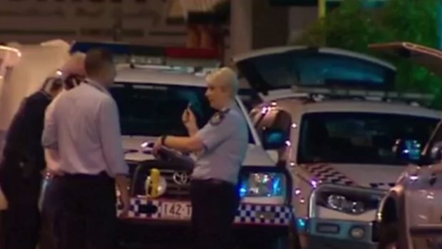 Police investigate after one of their colleagues shot a man at a Townsville service station. 