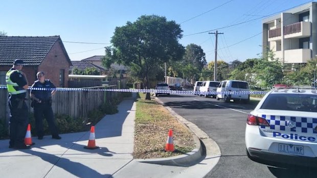 Police at the scene of the man's death in Mitcham.