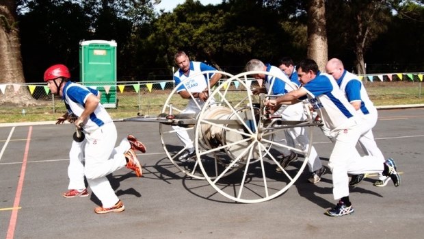 The South Hedland Brigade starting with their hose cart in one of the toughest events of the day.