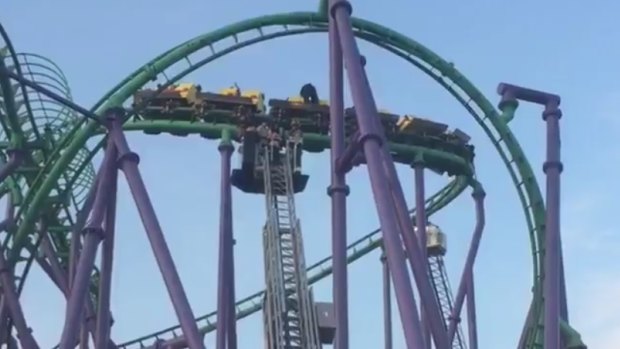 Riders are retrieved by emergency services after being stuck on 'The Joker's Jinx' at Six Flag America.