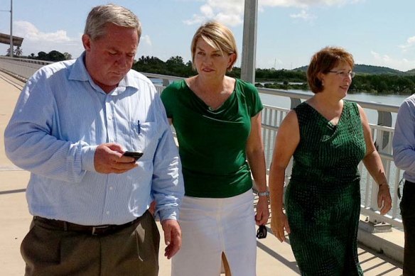 Then-premier Anna Bligh and Treasurer Andrew Fraser, with local MPs Tim Mulherin (Mackay) and Jan Jarratt (Whitsunday) walking over the Pioneer River. Photo: Tony Moore