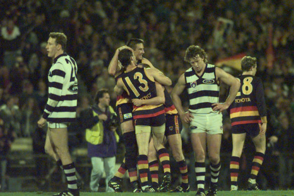 Crows jubilation after winning as Geelong’s Garry Hocking and Martin McKinnon mourn the loss.