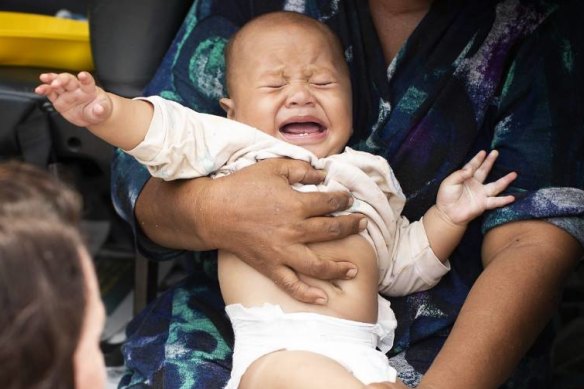 A baby receives a measles vaccination in Samoa.