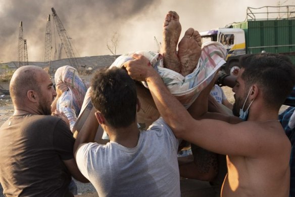 People evacuate wounded after the massive explosion in Beirut.