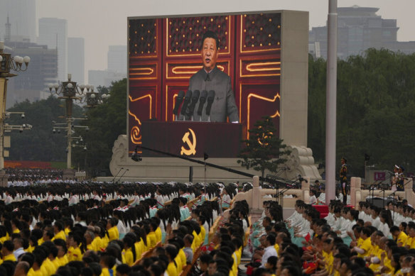 A screen shows Chinese President Xi Jinping speaking during a ceremony to mark the 100th anniversary of the founding of the Chinese Communist Party at Tiananmen Square in Beijing on Thursday.