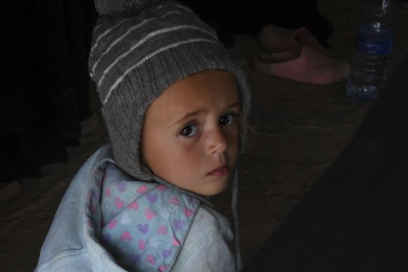 An Australian child sits on the ground of one of the tents among other Australian women and children in al Hawl camp last year.