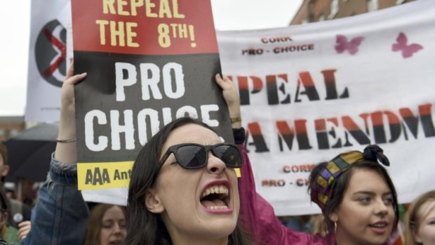 Demonstrators take part in a protest to urge the Irish Government to repeal the 8th amendment to the constitution, which enforces strict limitations to a woman's right to an abortion, in Dublin.