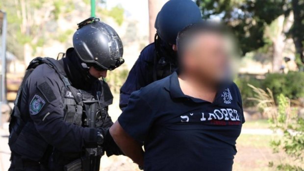 Police make an arrest in connection with the drug syndicate in February 2014.