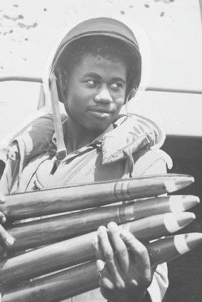 An African American soldier loads munitions during World War II.