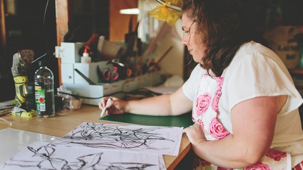 Artist Kim Bagot-Hiller with her botanical drawings.