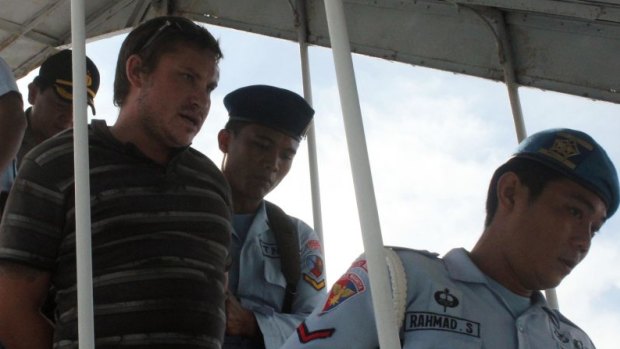 Australian Matt Christopher Lockley being taken off the flight by Indonesian officers.
