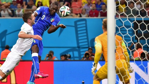 On fire: Balotelli scores against England.
