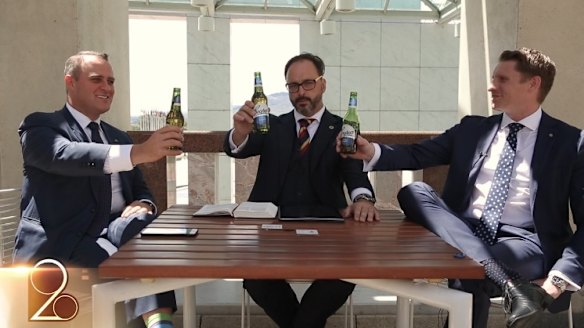Liberal MPs Tim Wilson, left, and Andrew Hastie, right, hold up Coopers beer bottles in the video.