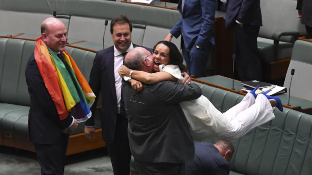 Liberal MP Warren Entsch hugs Labor MP Linda Burney as they celebrate the passing of same-sex marriage.