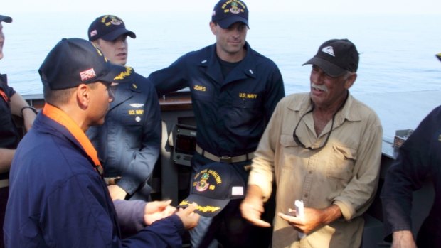 Navy Commander John Barsano welcomes Ron Ingraham aboard USS Paul Hamilton after his rescue on Tuesday. 