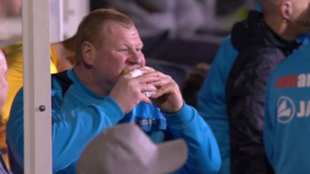 Tucking in: Wayne Shaw eats a pie in the dug-out during the FA Cup clash.