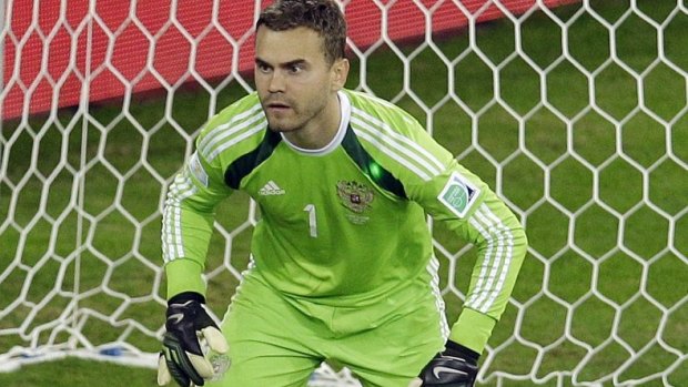 Russia's goalkeeper Igor Akinfeev is shown with a green laser dot on his shoulder.