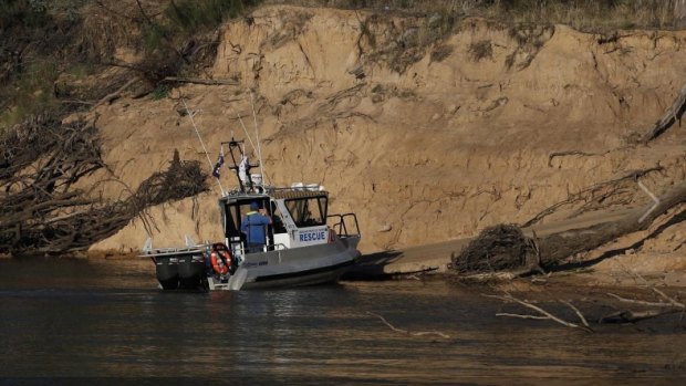 Police divers search the Murray River for the five-year-old