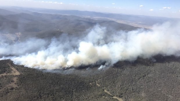 A prescribed burn in Namadgi National Park jumped containment lines on Sunday as Canberra sweltered in temperatures that topped 31 degrees Celsius.