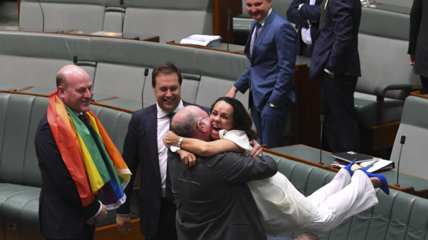 Liberal MP Warren Entsch hugs Labor MP Linda Burney as they celebrate the passing of the Marriage Amendment Bill in the House of Representatives.