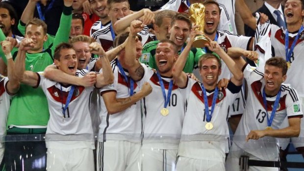 Bastian Schweinsteiger of Germany lifts the World Cup trophy with