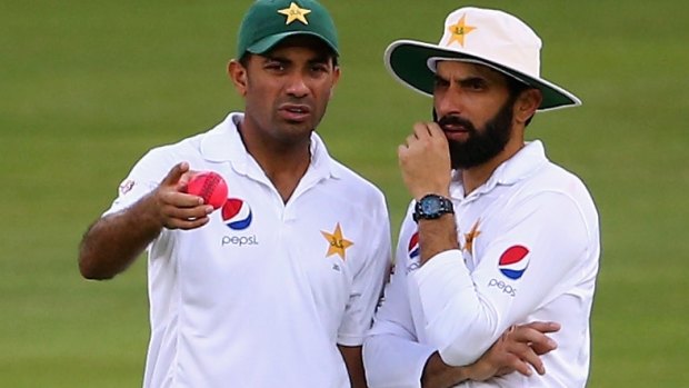 Pakistan's Wahab Riaz and Misbah-ul-Haq confer during the First Test against the West Indies in Dubai.