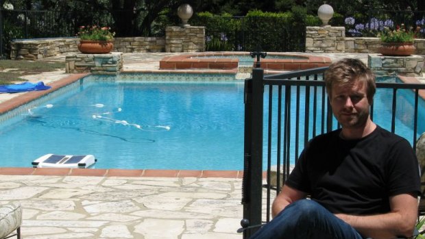 Entrepreneur and chief executive officer of LIFX, Phil Bosua, sits beside his company's pool.