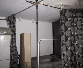 Residents installed makeshift curtains to divide the lounge room to make more sleeping space.
