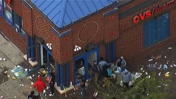 Looting: A still from local tv station WJLA shows people gathering near a store on Monday.
