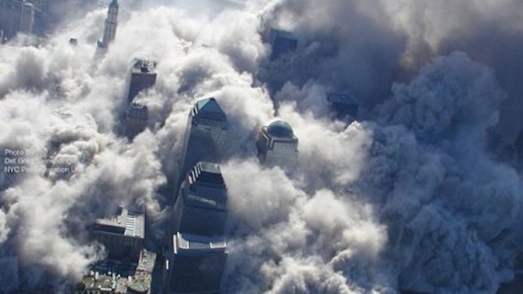 The burning buildings collapse amid huge plumes of smoke. 