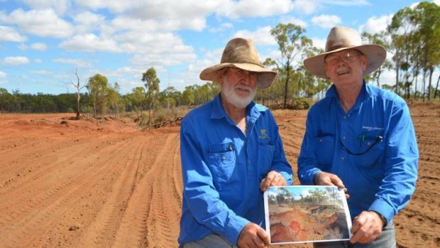 Beef producer David Nicholas (left), pictured with Queensland Agriculture Department officer Bob Shepherd at a gully rehabilitation project on his property, fears he will lose his farm, which has been in the family since 1963.