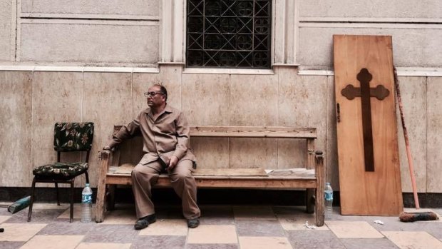 A man rests on a bench in Tanta following the church attack.