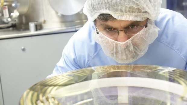 CSIRO technicians work on one of the mirrors to be used in LIGO in the detection of gravitational waves.
