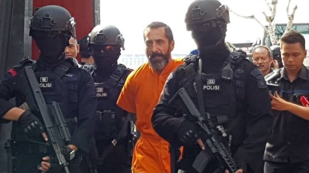 Dimitar Nikolov Iliev (pictured), from Bulgaria being escorted by armed police in Bali.