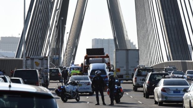 Police directing traffic on the Anzac Bridge after a crash on Tuesday morning. 