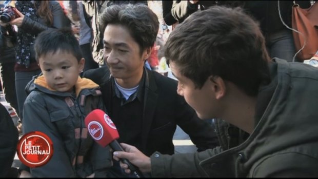 Brandon and his father, Angel Le, are interviewed by a reporter for French TV show <em>Le Petit Journal</em>.