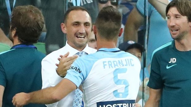 Ivan Franjic celebrates with Melbourne City interim coach Michael Valkanis after scoring at AAMI Park on Friday night.