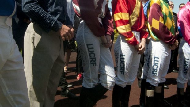 Health and pay fears: Jockeys gather at the winners area at Doomben racecourse to pay their tributes to Tim Bell in November last year.