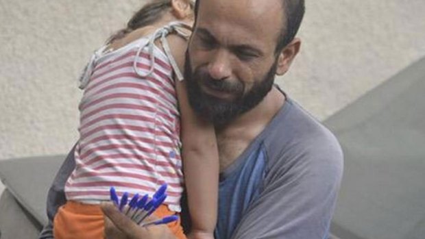 The photo that transformed their lives: Syrian refugee Abdul Halim al-Attar selling pens on the streets of Beirut with his daughter Reem.