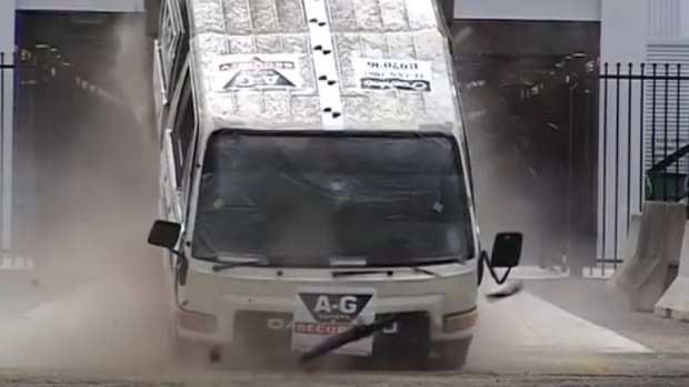 This image shows the moment a speeding truck hits a bollard.