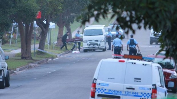 Mr Davey's body is removed from the scene on Stafford Street, Kingswood, on Wednesday morning.