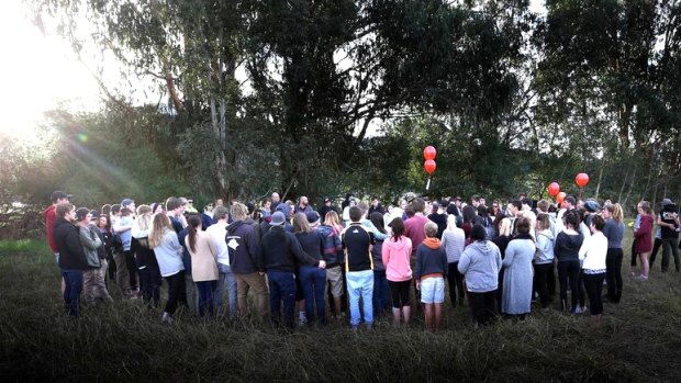 Family and friends pay tribute to Spencer at the crash site on Sunday.