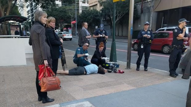 Paramedics treat Mark English, allegedly coward punched on Ann Street in the Brisbane CBD.